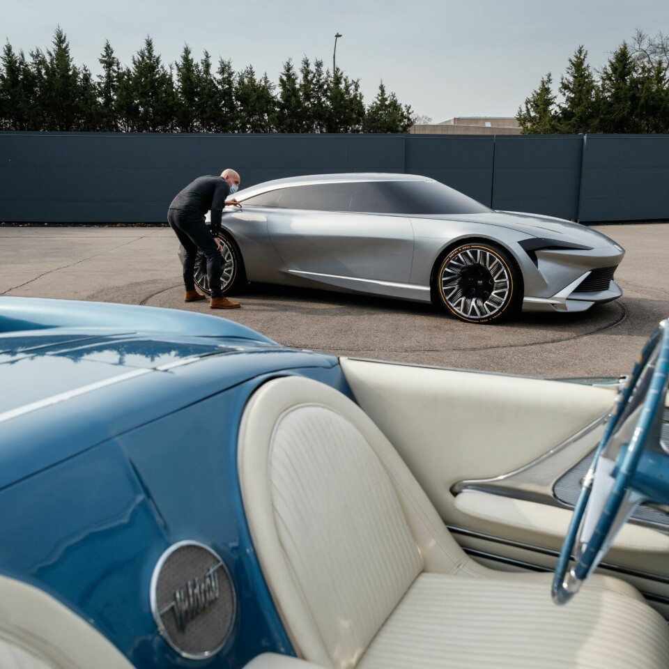 Buick design manager Kevin Nougarede studying lines on the 2022 Buick Wildcat EV with 1954 Wildcat in the foreground Buick Design Manager Kevin Nougarede studying lines on the 2022 Buick Wildcat EV model with 1954 Wildcat in the foreground