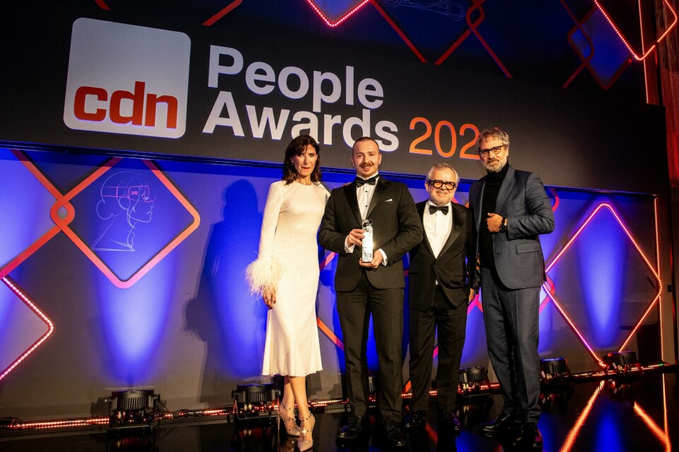 Freddie Holmes accepts the Best CMF Team award from Jürgen Uedelhoven CEO of UE Studios 20241205_CDN_PeopleAwardPresentations-3