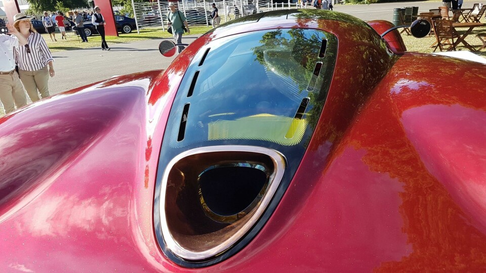 Ferrari-based V12 gets straight pipes, all fed to this copper-laden exit Ferrari-based V12 gets straight pipes, all fed to this copper-laden exit